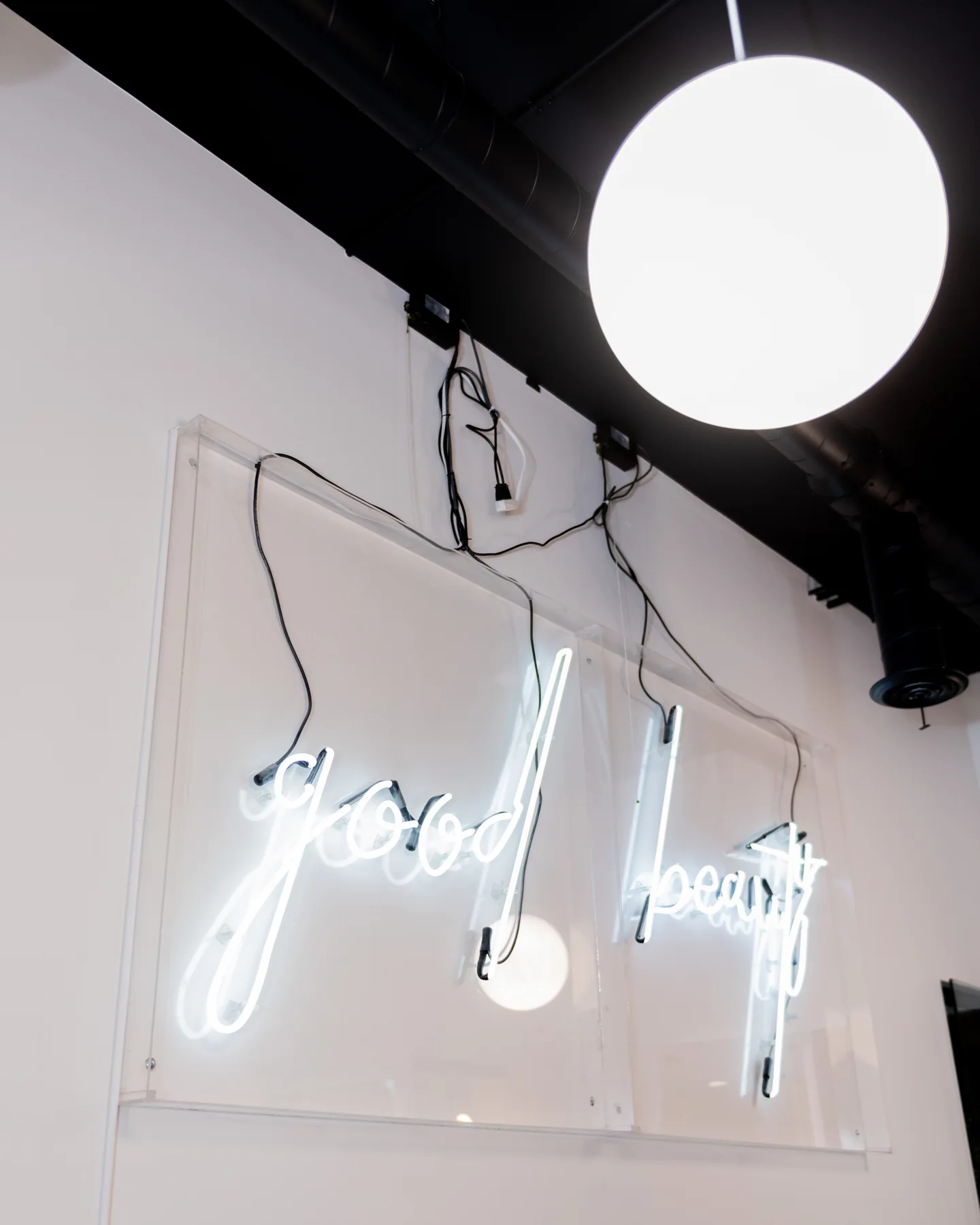 Neon good beauty script sign glowing on the salon wall